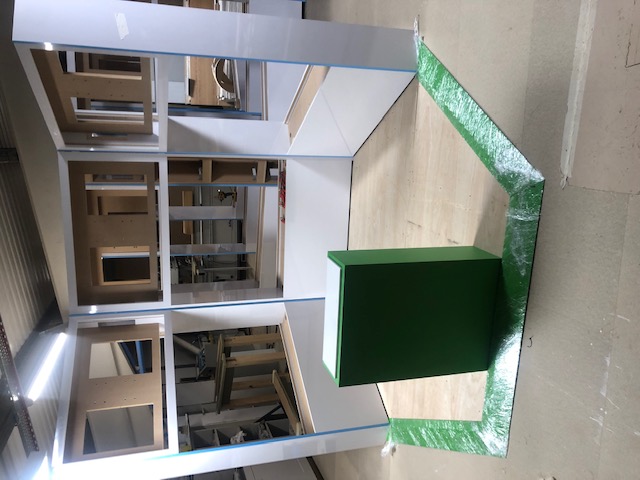 Xbox display unit under construction in Novus workshop with green branding and white gloss panels